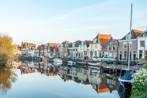 River with Boats in Town, between Buildings