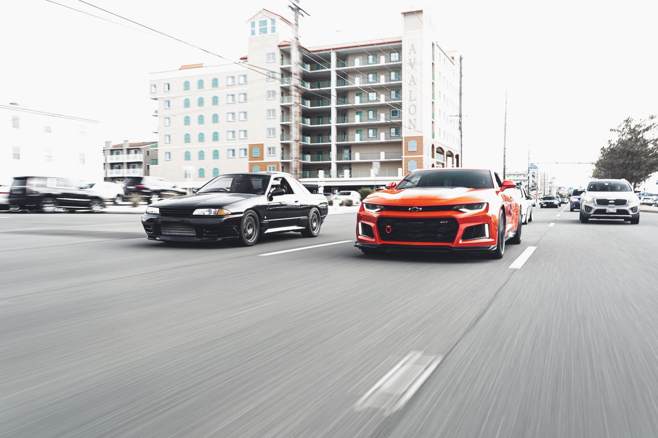 dynamic shot of two high performance cars racing on a city street with