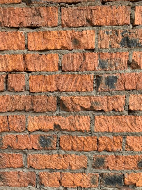 Detailed close-up of a red brick wall showcasing texture and pattern.