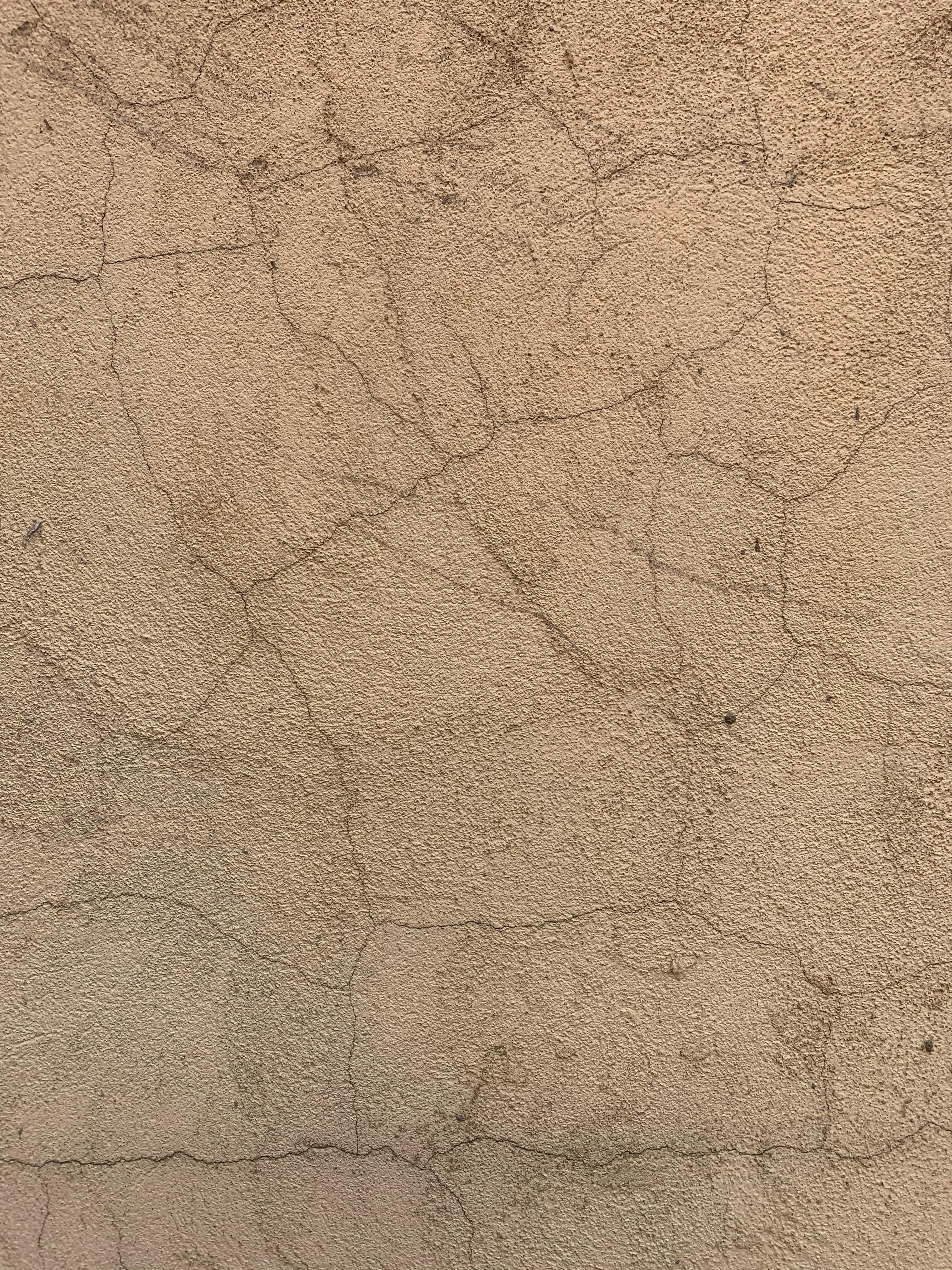 Close-up of a weathered and cracked concrete wall showcasing texture.