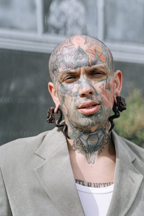 Close-up Photo of Tattooed Man in Gray Blazer 