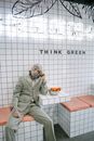Man in Gray Coat Sitting on Chair