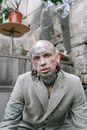 Man in Grey Suit Jacket With Face Paint