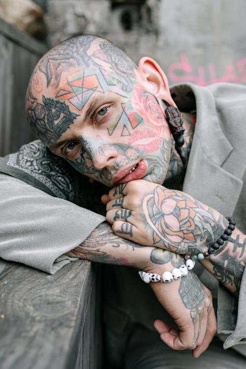 Close-up Photo of Tattooed Man in Gray Blazer
