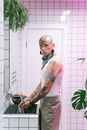 Man in White Tank Top and Gray Pants With Face Paint