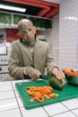 Man in Brown Suit Jacket Holding Sliced Carrots