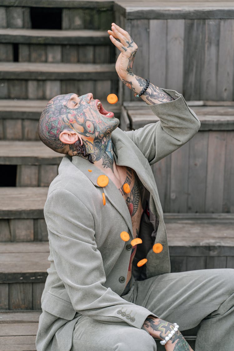 Tattooed Man Eating Sliced Carrot