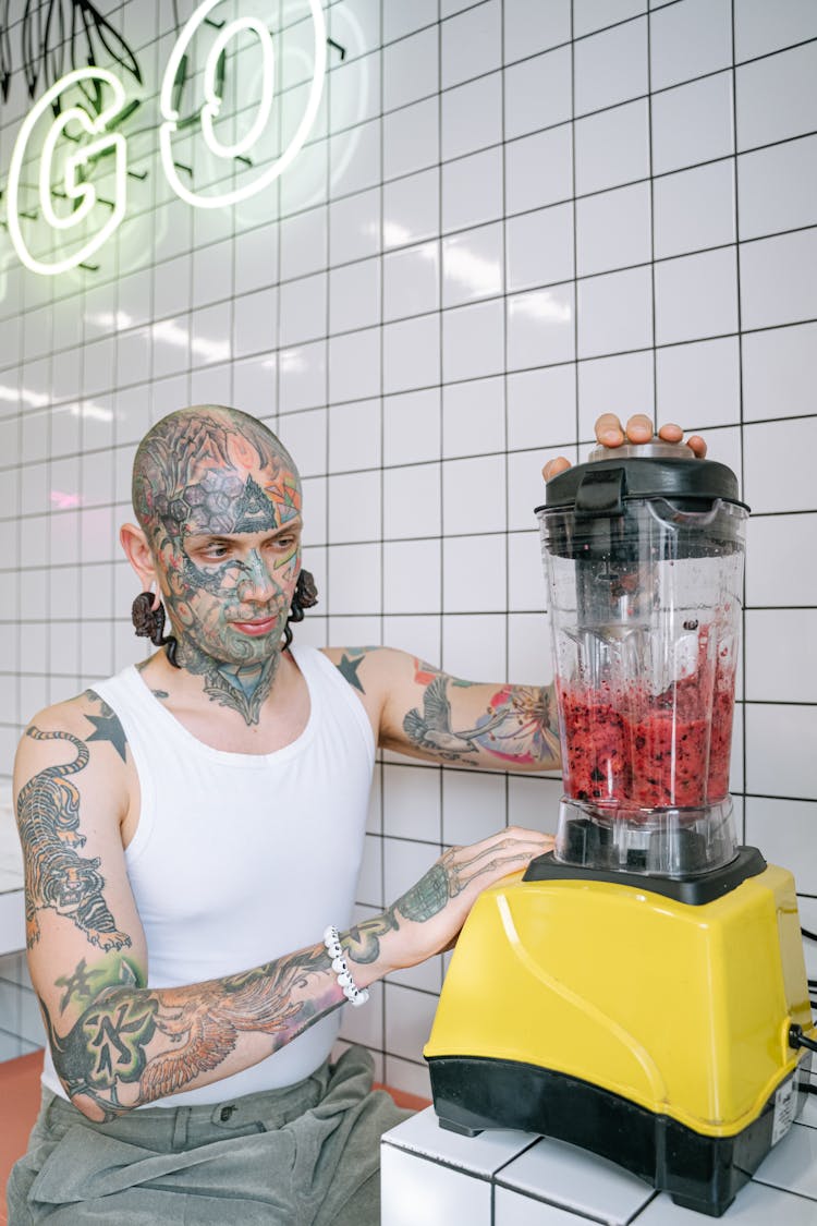 Man In White Tank Top Using A Blender