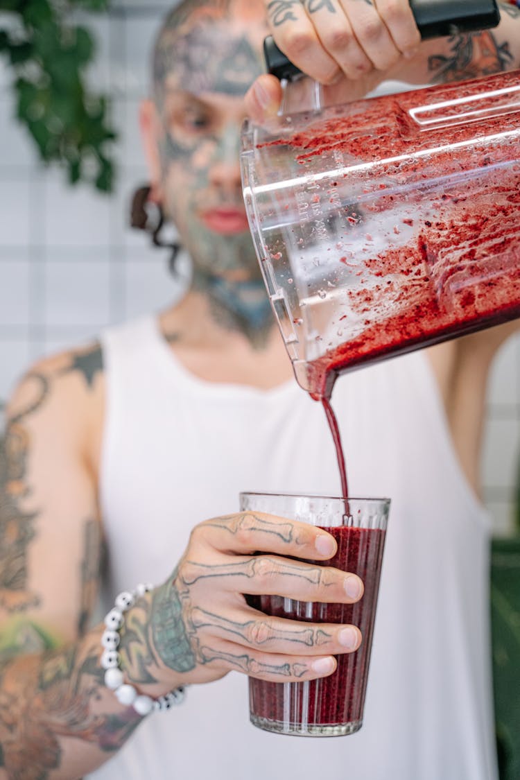 Pouring Of Fruit Smoothie On Glass