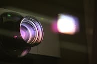 A Black Camera Lens Reflecting Square Light