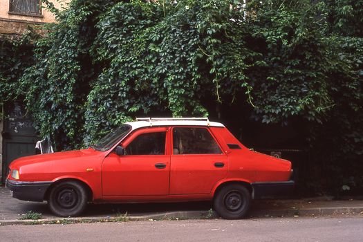 Red Sedan Parked on the Roadside