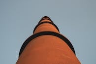 Industrial Brick Tower against Blue Sky