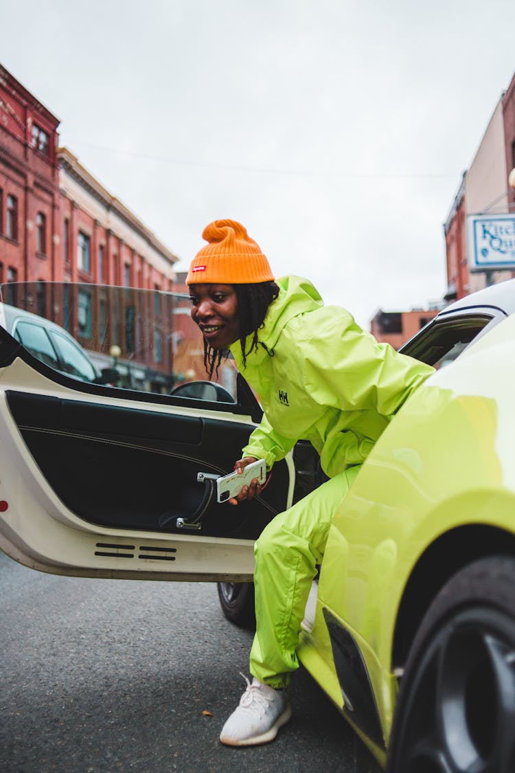 Smiling African American Man Getting Out Of Contemporary Sports Car