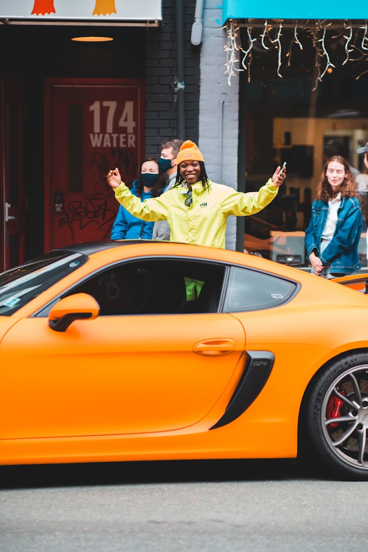 Content African Man Near Expensive Racing Car In Town