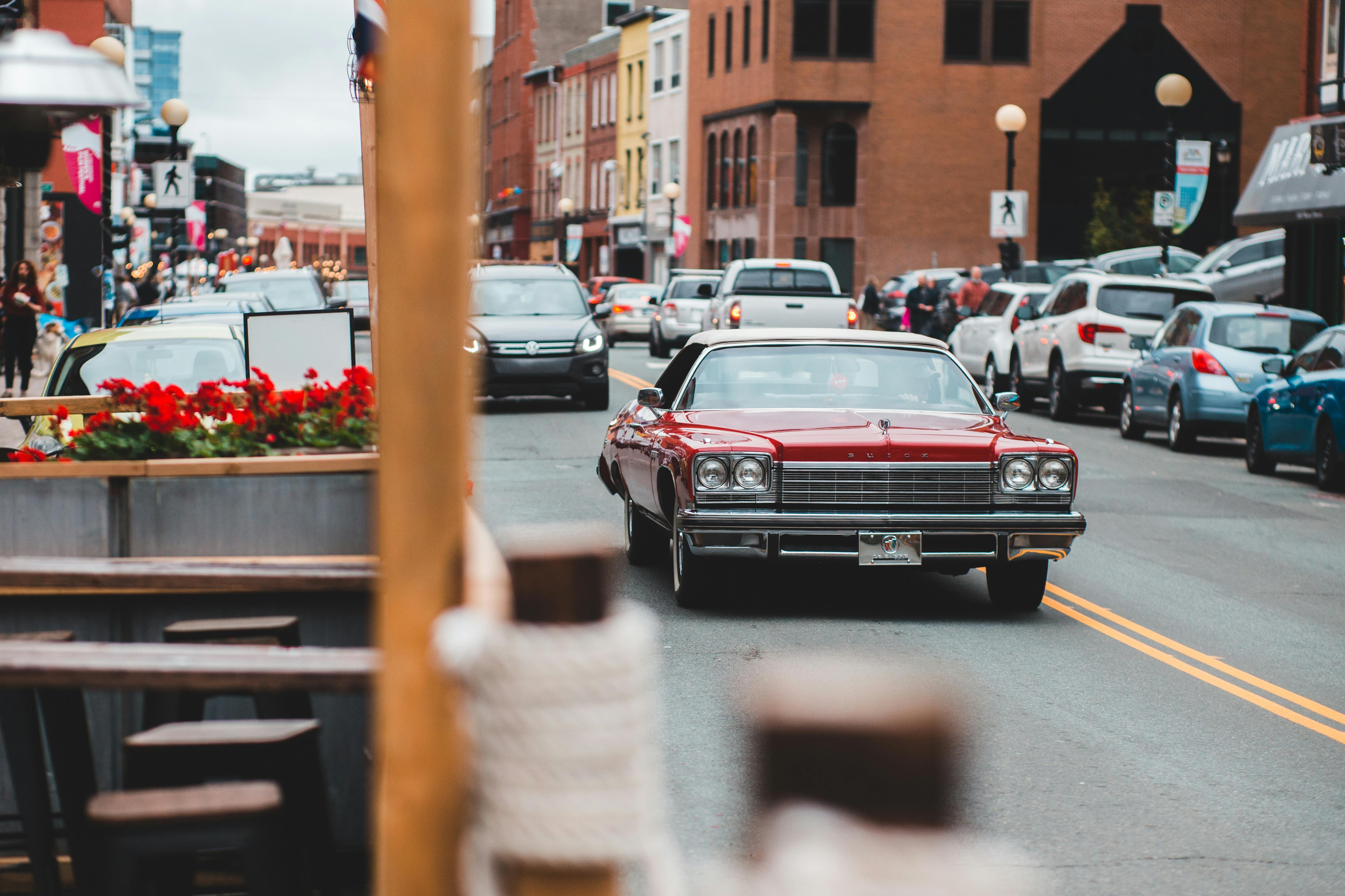 old fashioned car on road near aged buildings