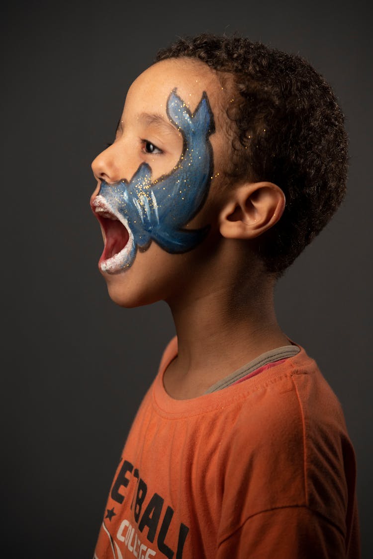 Child With Shark Painting On Face