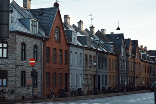Picturesque European townhouses lining a quiet city street, evoking architectural charm.