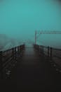 Bridge in foggy weather in day in street near water