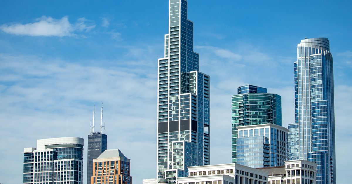 A city's skyline with tall skyscrapers under a clear blue sky.
