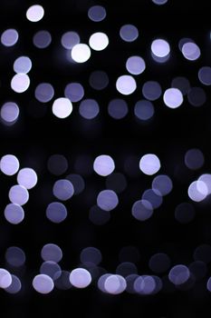 Blurred bokeh lights on a dark background create a magical and abstract visual effect.