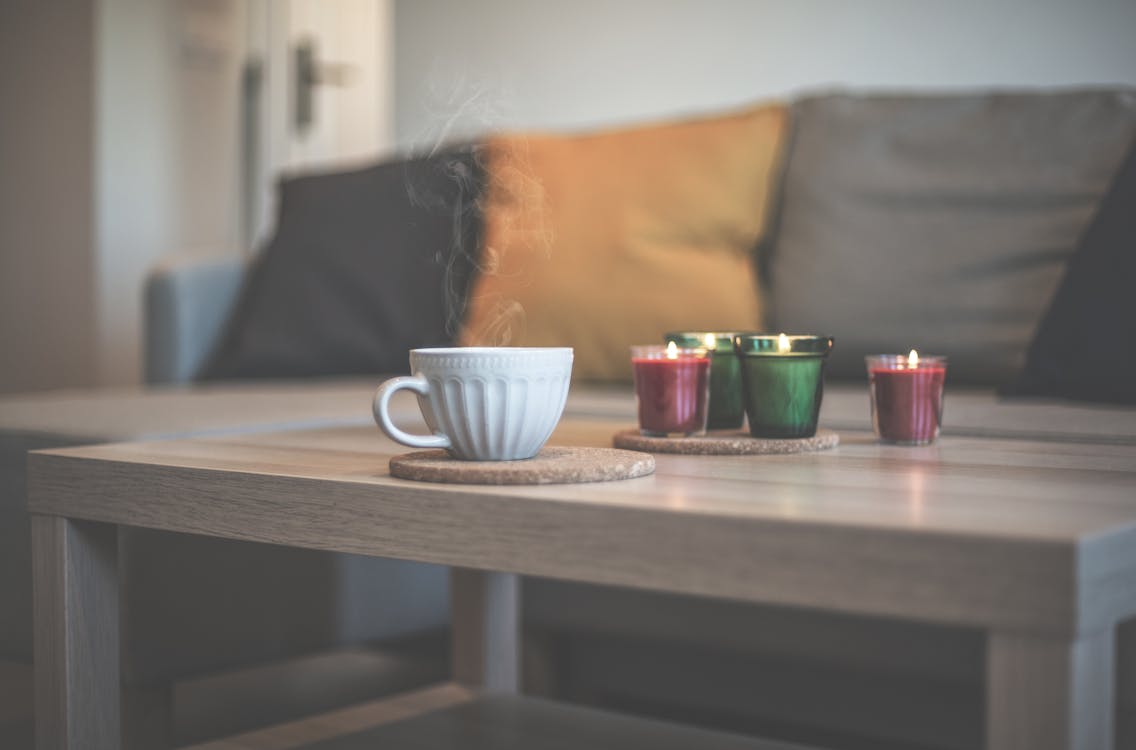 Free Cup of Hot Coffee by Candles Stock Photo
