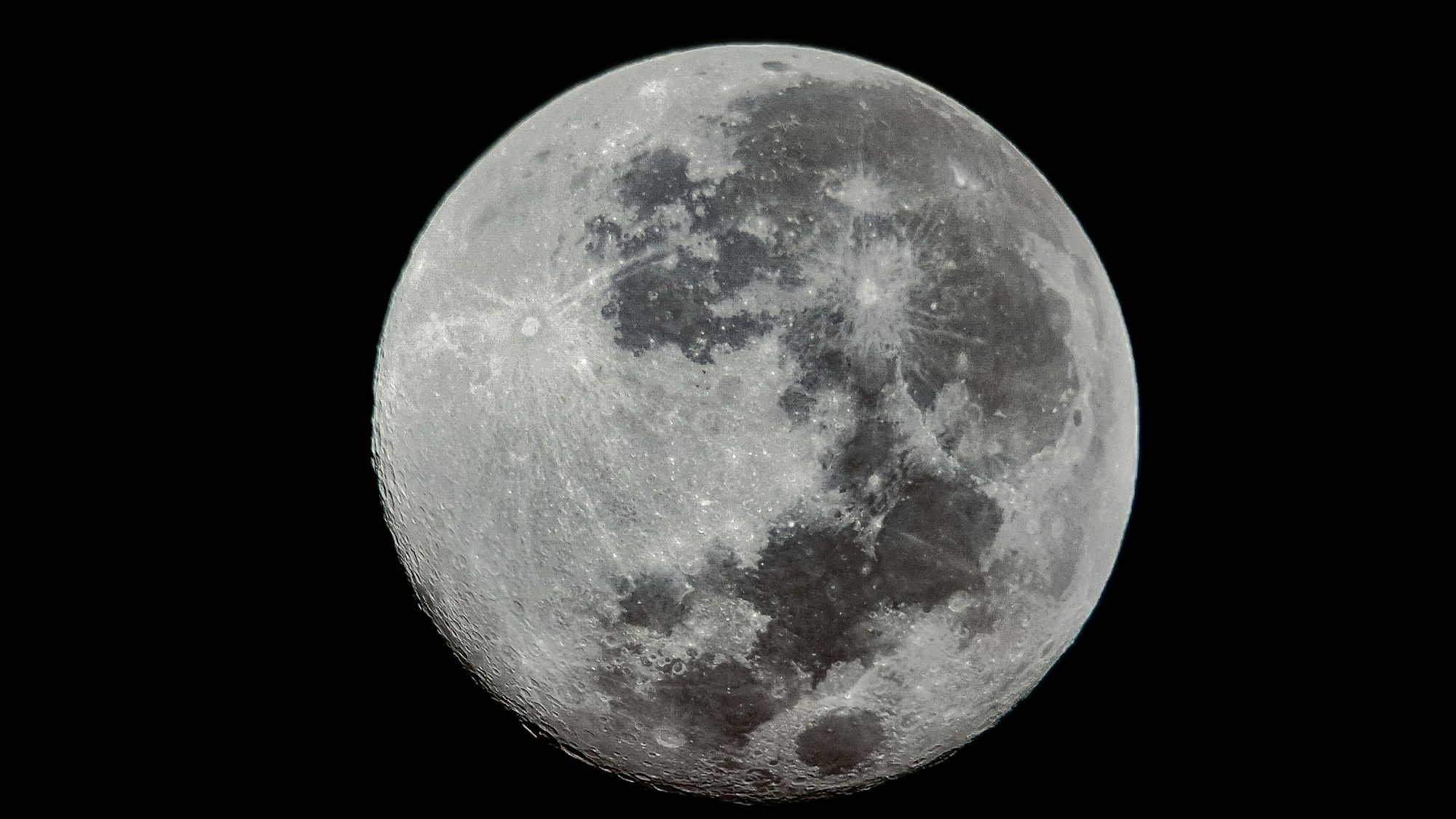 High-resolution close-up of the full moon with visible craters and texture.