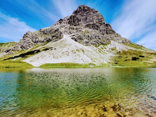 Free Stunning view of a mountain and lake in Vorarlberg, Austria on a clear summer day. Stock Photo
