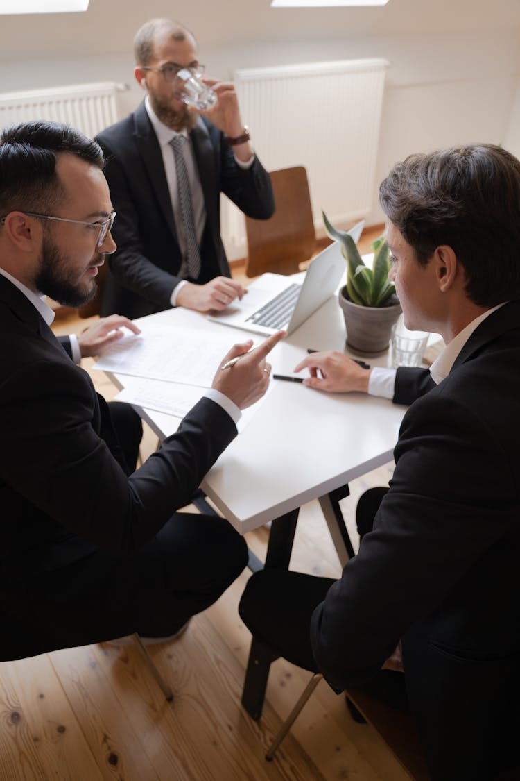 Men In Business Suits In A Meeting