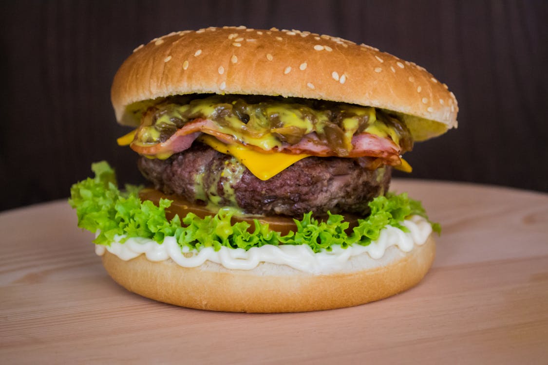 Free Burger on Brown Surface Stock Photo