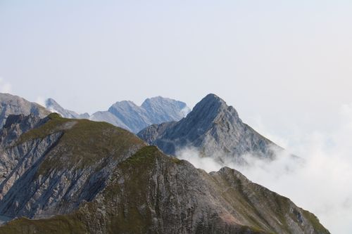 Free Beautiful aerial view of the rugged mountain peaks of the Swiss Alps in Furna, Switzerland, surrounded by mist. Stock Photo