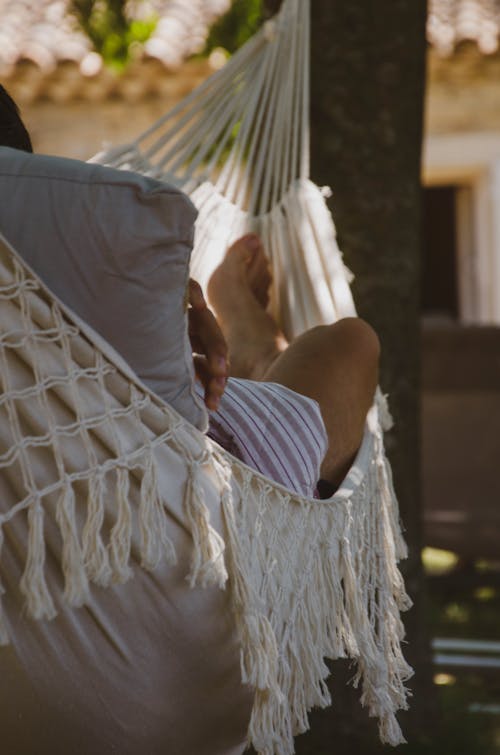 Free Selective Focus Photo of a Person Lying on a Hammock Stock Photo