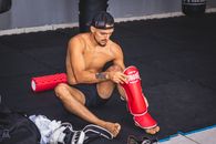 Topless Man Wearing Black Sunglasses Sitting on Red Yoga Mat