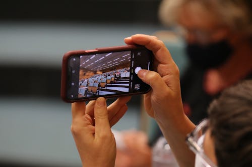 Free A Person Taking a Photo of an Auditorium Stock Photo