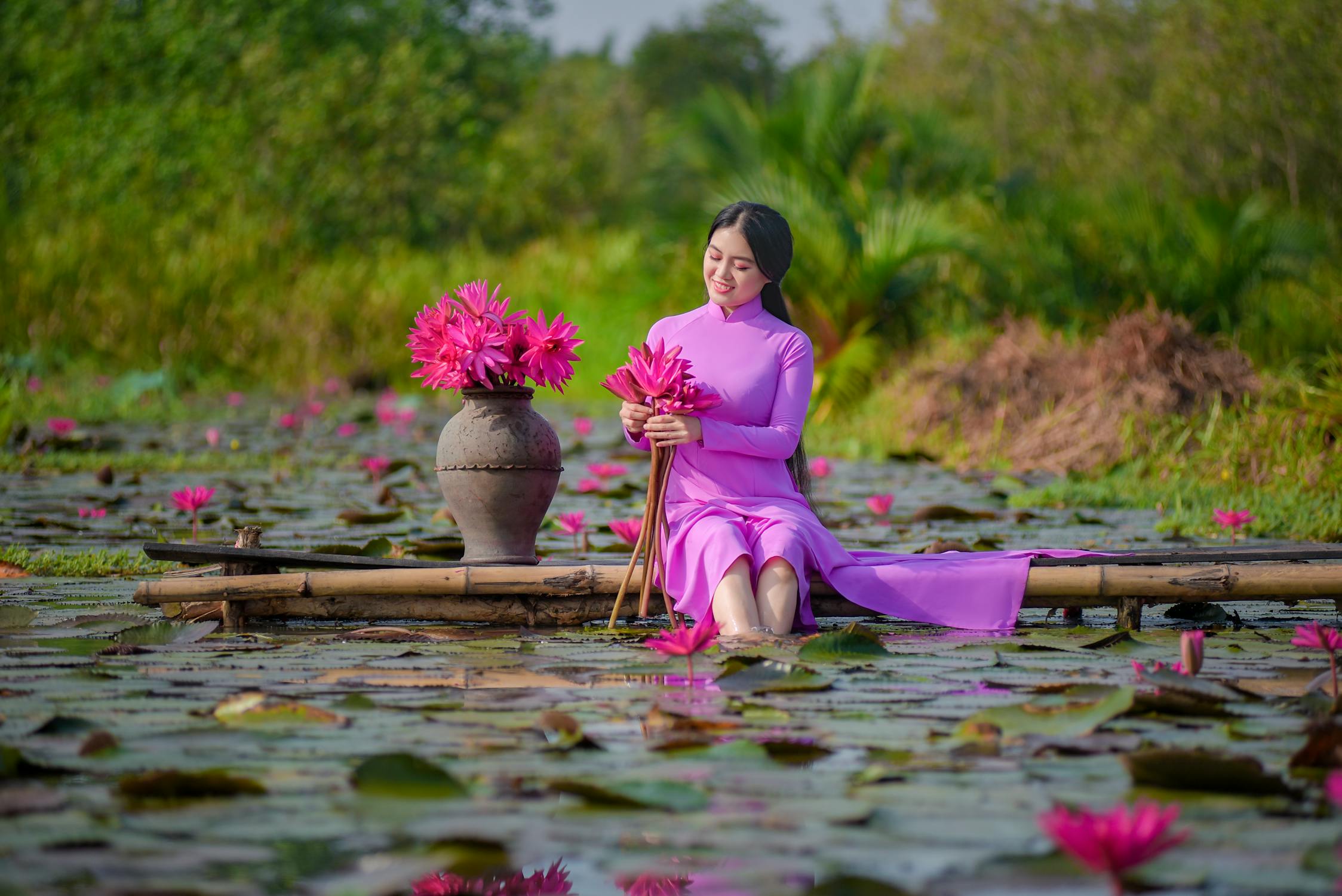 Korean Girl Photo by Phát Trương from Pexels: https://www.pexels.com/photo/a-woman-in-pink-dress-sitting-near-the-lake-while-holding-pink-flowers-5521412/