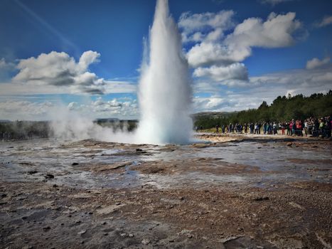 People Watching a Geyser Eruption 