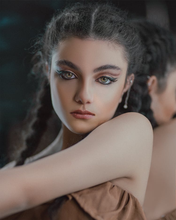 Young Woman With Makeup Against Mirror