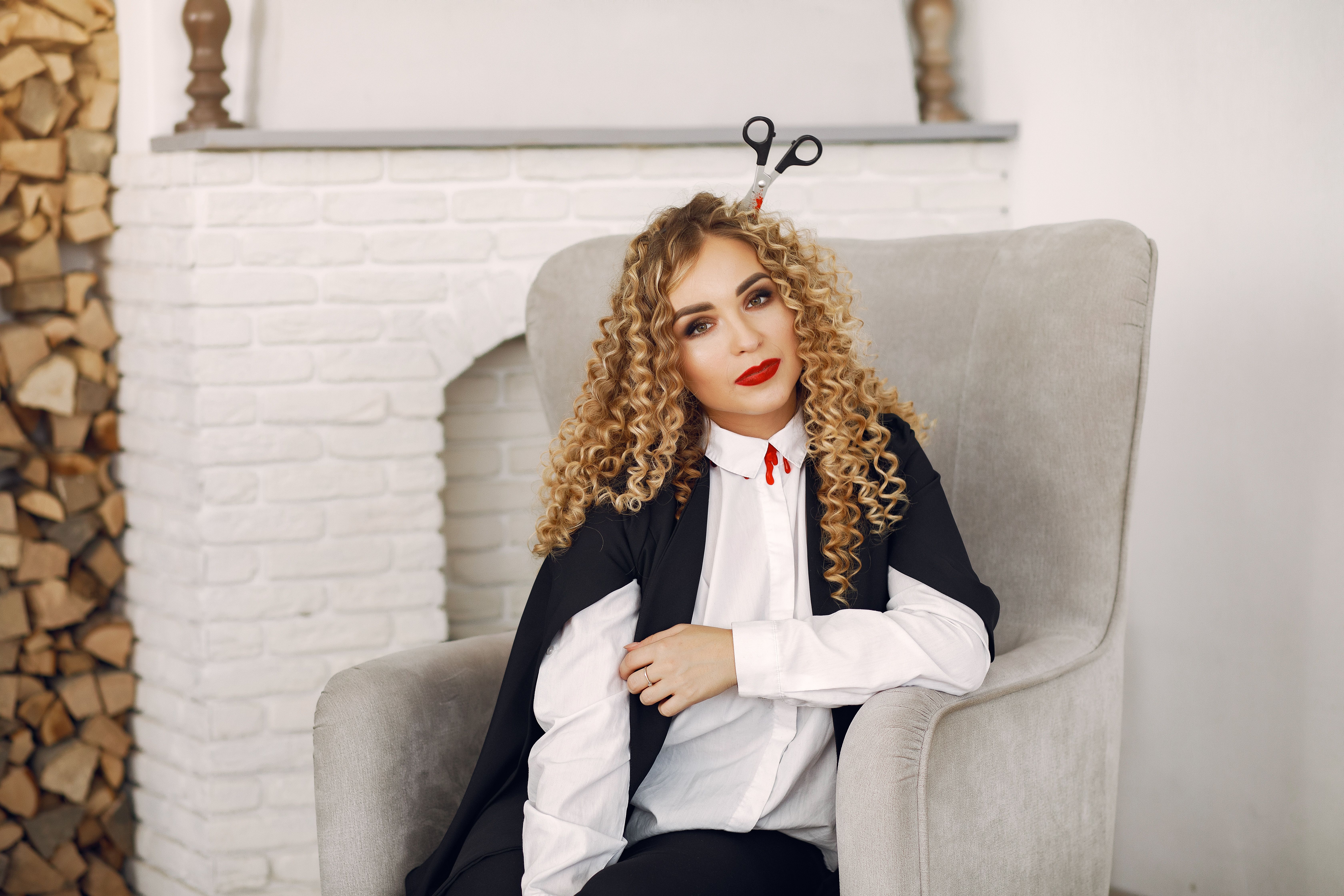 A Woman in a Costume Sitting on a Chair · Free Stock Photo