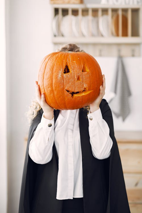 A Jack-o'-Lantern Covering a Person's Face