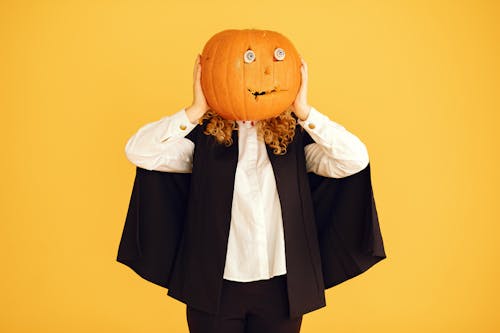 Person Holding a Carved Pumpkin