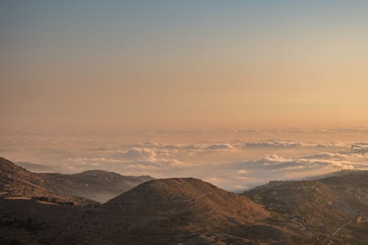 Stunning aerial view of Faraiya, Lebanon, showcasing a sea of clouds over mountains during sunrise.