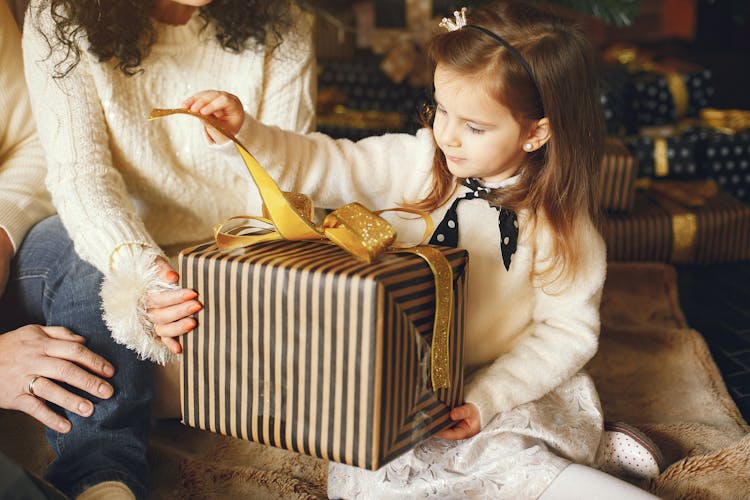 A Girl Opening A Gift Box