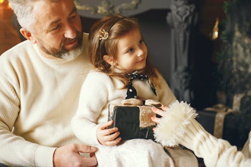 Free Cute Daughter Receiving a Christmas Present Stock Photo