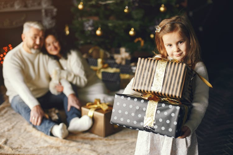 A Girl Carrying Christmas Presents