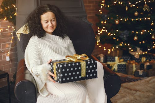 A Woman Holding a Christmas Present