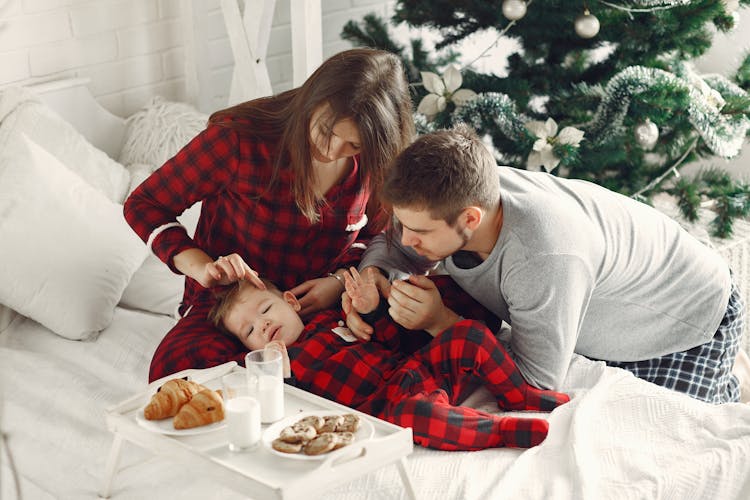 Couple Waking Up Baby For Breakfast In Bed