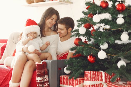 Happy Family with Child near Christmas Tree