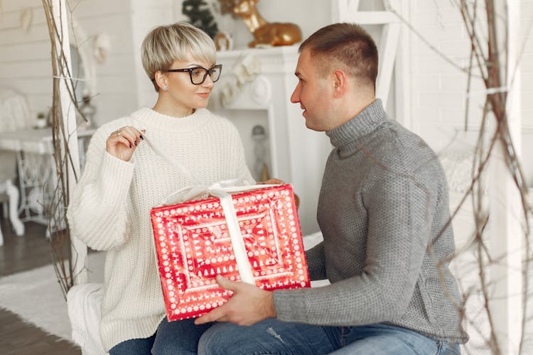 Happy Couple Unpacking Present Together