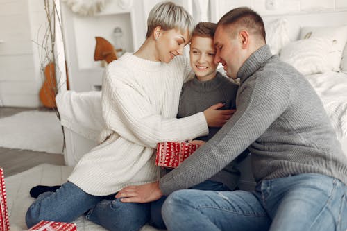 Family Sitting on Sofa Sharing Happy Moments Together