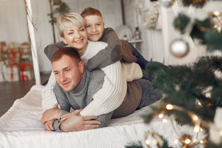 Family On Bed Together On Christmas