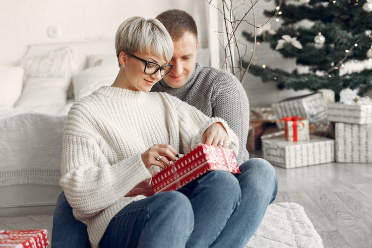 Couple Opening A Christmas Gift